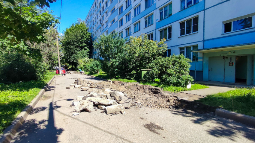 Разборка асфальта и куча бетонного лома на внутридворовом проезде у многоэтажного дома