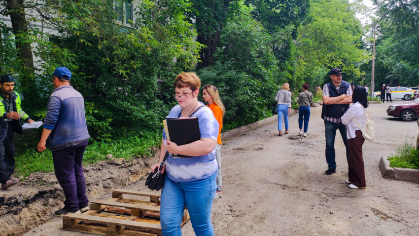 Жители и рабочие обсуждают ремонт дворового проезда у зелёных насаждений