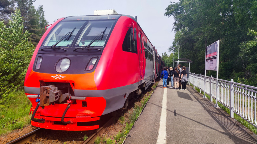 Пригородный электропоезд у платформы и табличка остановочного пункта «Прибылово»