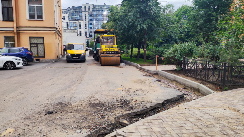 Дорожный каток BOMAG на ремонте покрытия с разбором асфальта и установкой бордюров
