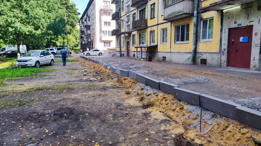 Земляные работы во дворе: траншея и песчаная подсыпка под бордюр у жилого дома