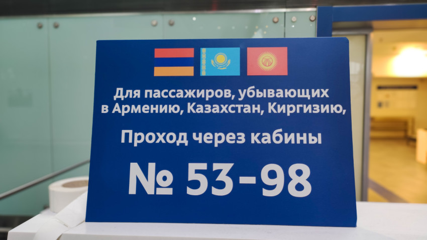 Табличка с флагами и направлением на кабины №53–98 для трёх стран
