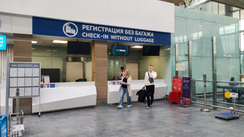 Вывеска «Регистрация без багажа / Check-in without luggage» над окнами обслуживания
