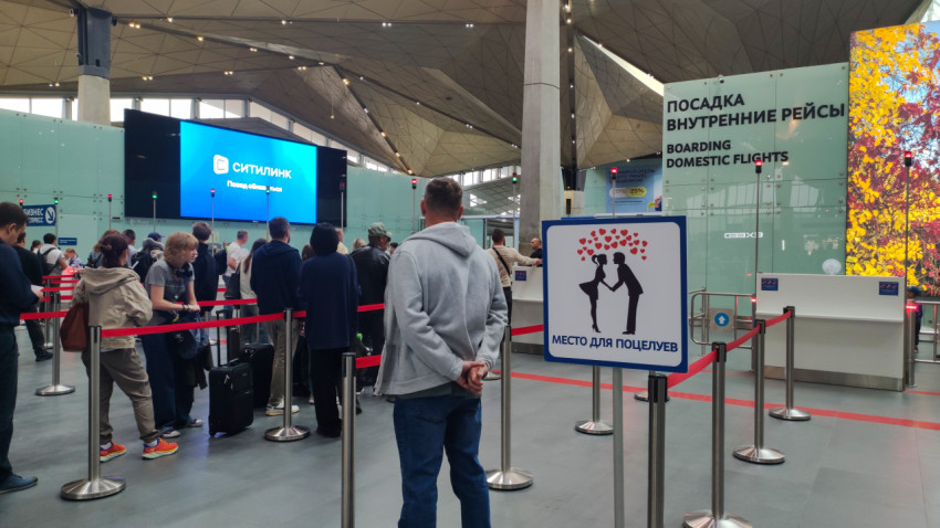 Очередь на посадку внутренних рейсов и знак «место для поцелуев»
