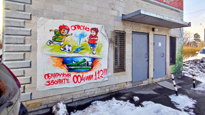 Граффити на стене здания с изображением детей, играющих в футбол