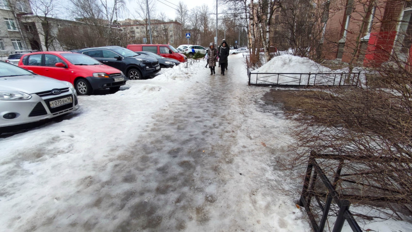 Люди идут по гололеду на тротуаре