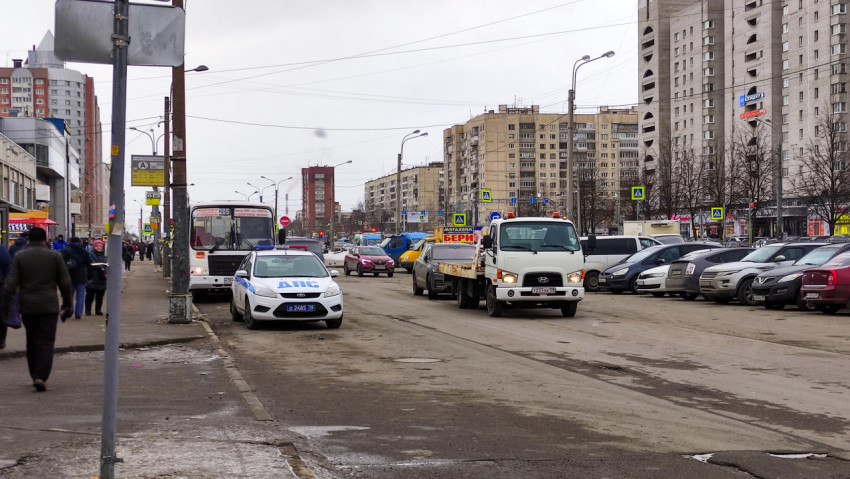 Грузовик-эвакуатор и дорожная полиция на улице города