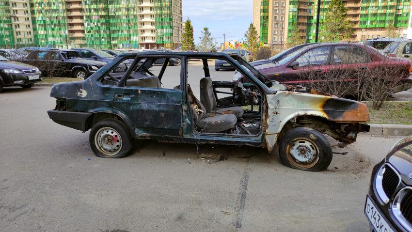 Сгоревшая машина на парковке в жилом районе