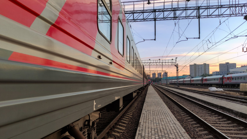 Пассажирский поезд у платформы на закате