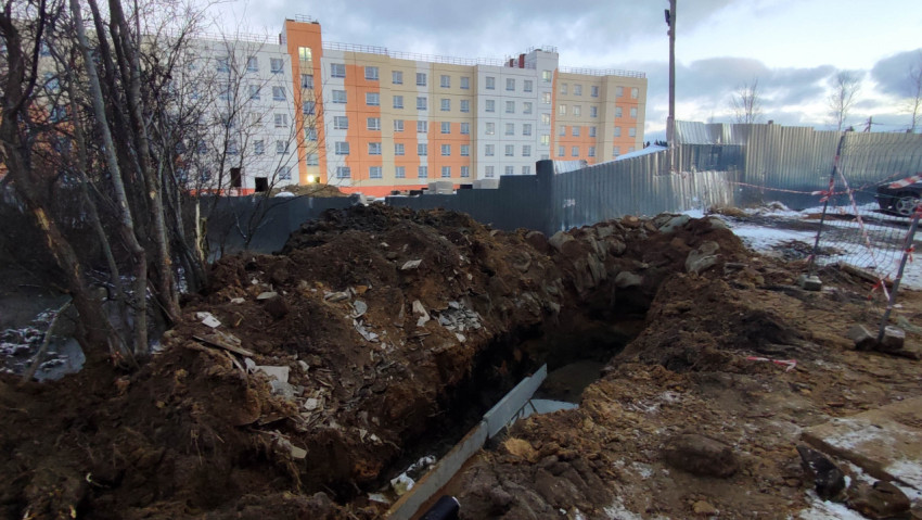 Глубокая траншея на строительной площадке рядом с жилым домом