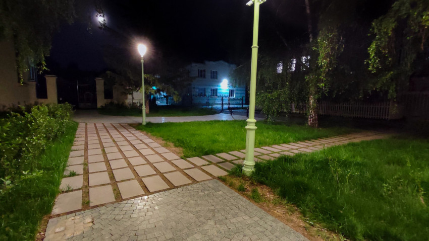 Освещённая аллея в жилом районе ночью