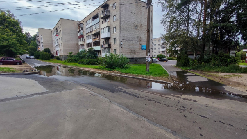 Лужа на проезжей части у жилых домов