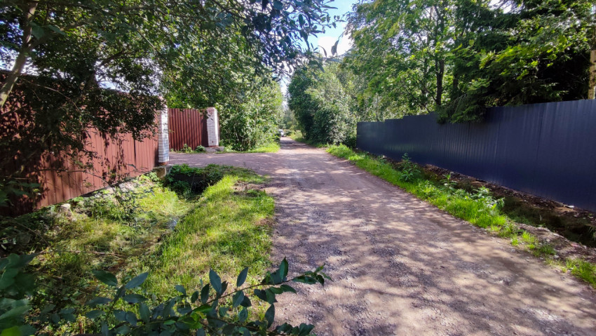 Деревенская дорога с канавами и ограждениями