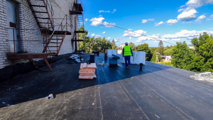 Рабочие материалы и монтаж на плоской крыше здания