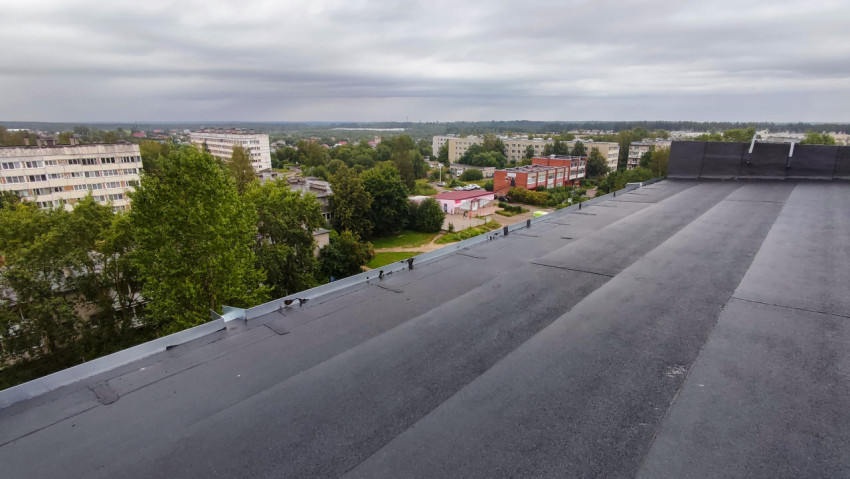 Плоская крыша здания и панорама жилого квартала