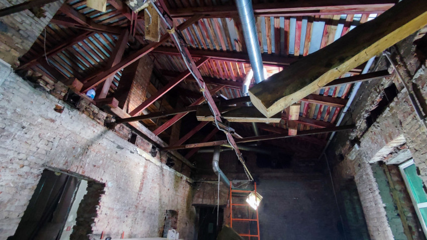 Металлические стропила и кирпичные стены в процессе реконструкции кровли