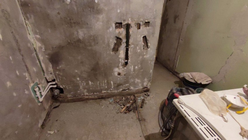 Расчистка стены и инженерных коммуникаций при ремонте