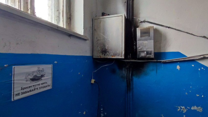 Угол подъезда с электросчетовым шкафом и предупреждающей табличкой