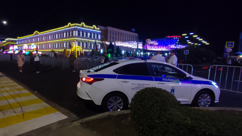 Патрульная машина на фоне ярких гирлянд и городской суеты