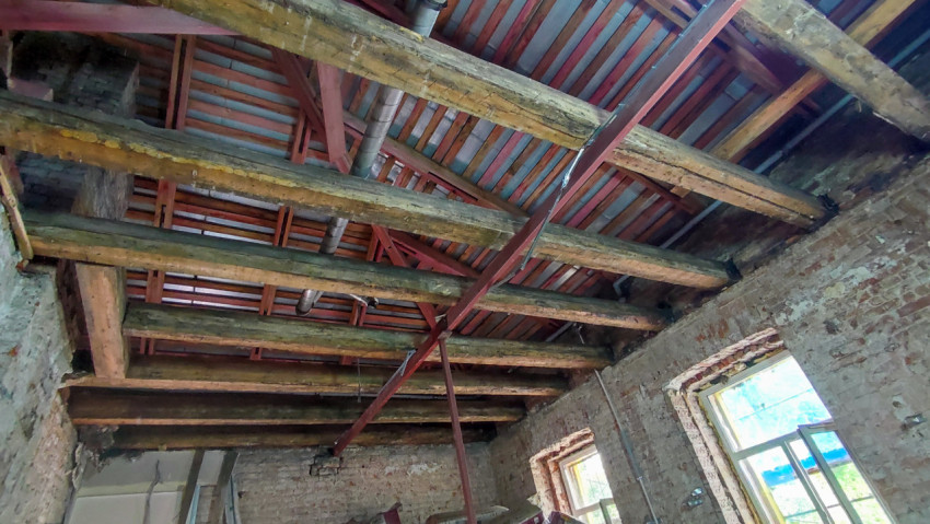 Деревянные балки и металлические фермы кровли старого здания