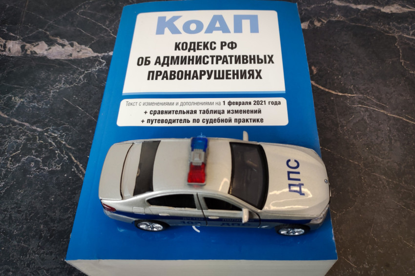 Полицейская модель машины на книге КоАП РФ