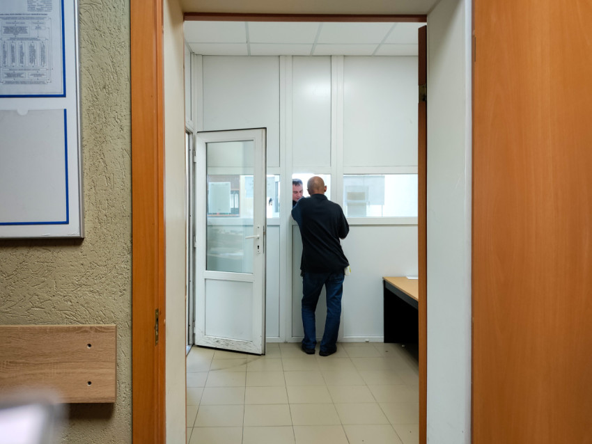 Посетитель у окна приёма в административном здании