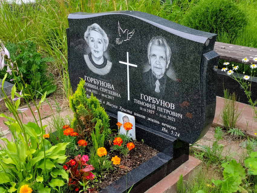Двойной гранитный памятник с портретами Горбуновой и Горбунова и религиозной надписью