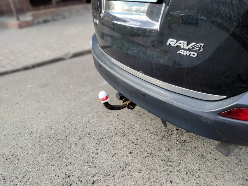 Задний фаркоп Toyota RAV4 с крышкой от Kinder на парковке