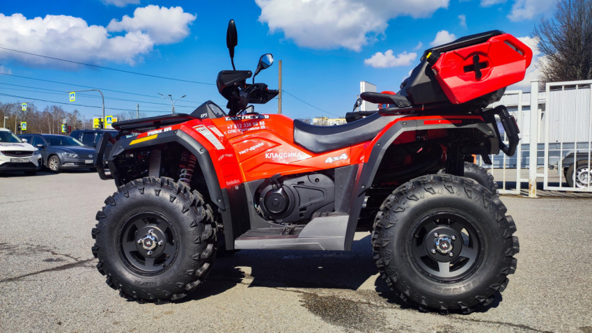 Красный квадроцикл Stels 4x4 на открытой площадке