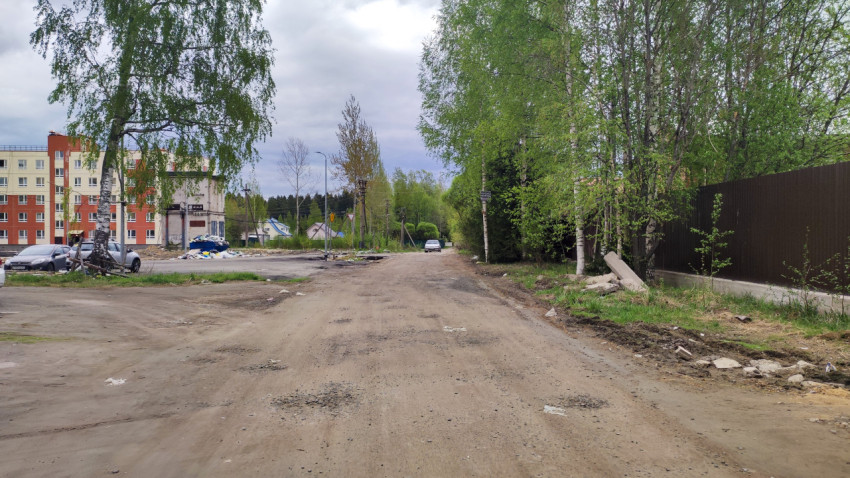 Грунтовая дорога с видом на новые и старые постройки