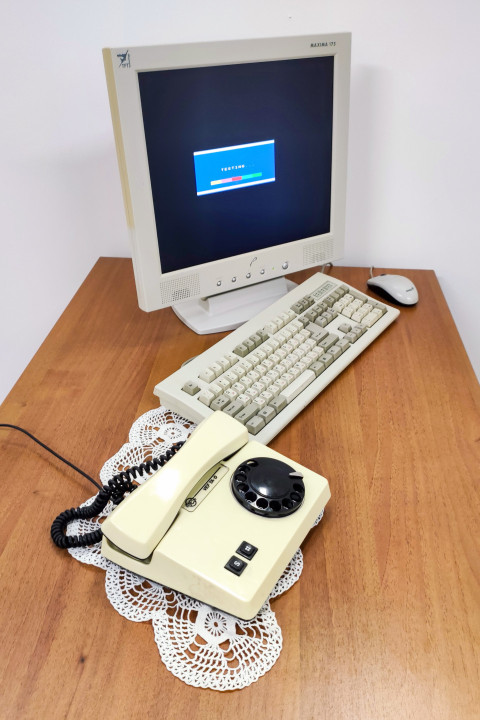 Ретро-компьютер и дисковый телефон на деревянном столе