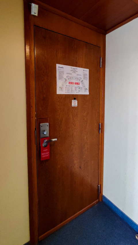 Дверь гостиничного номера в отеле Cosmos с планом эвакуации