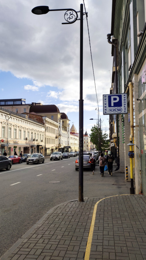 Улица с автомобильным движением и парковкой в центре Казани