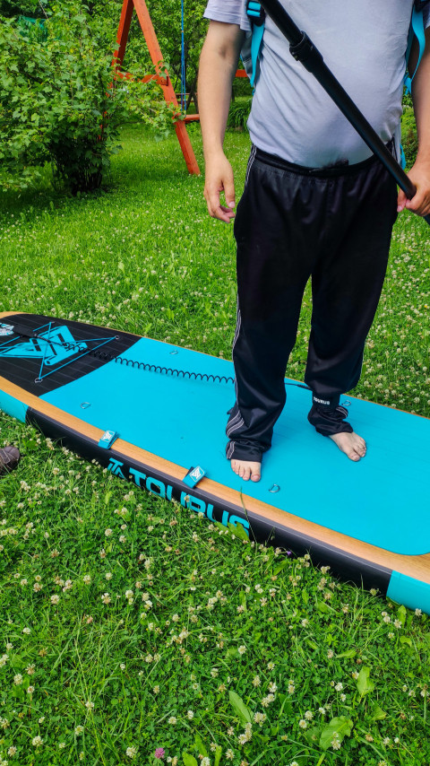 Фрагмент SUP-доски с ногами мужчины