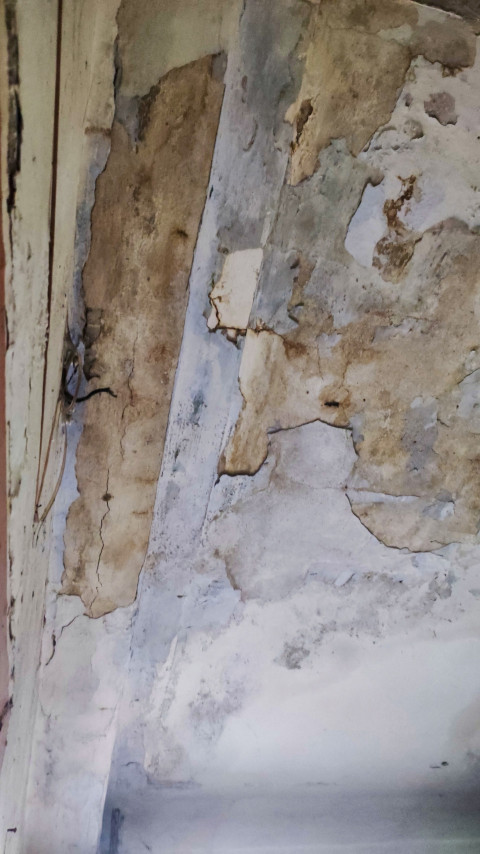 Фрагмент стены с осыпающейся штукатуркой